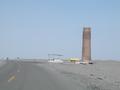 Old watchtower with derelict gas station at its foot